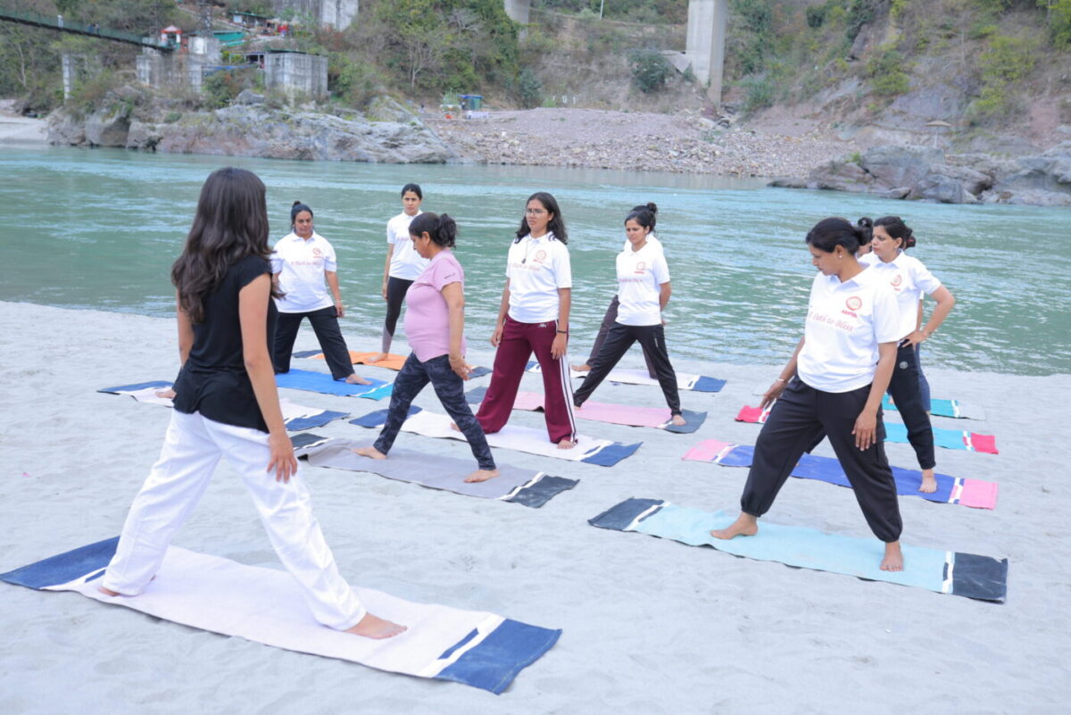 Art of Yog teacher guiding a student during yoga practice